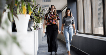 Photo of two women walking towards camera